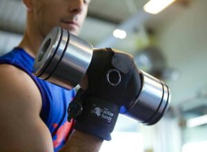 Rob holding free weight with General Purpose aid. Adaptive gym equipment. Suitable for reduced hand function: tetra, quad, cerebral palsy, SCI, spinal cord injury, limb difference, stroke and more.