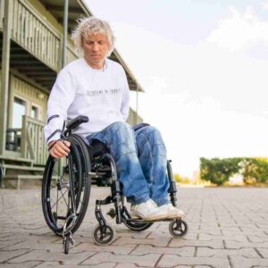 Reacher/ grabber man reaching keys on floor. Suitable for reduced hand function: tetra, quad, cerebral palsy, SCI, spinal cord injury, stroke and more.