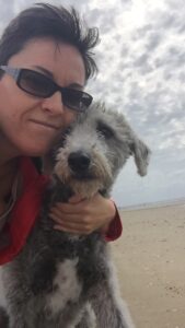 Nat and her dog, Stan cuddle close for a selfie on the beach.