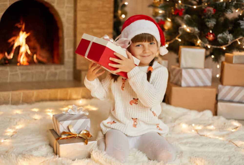 Girl listens to present to see if she can guess what it is