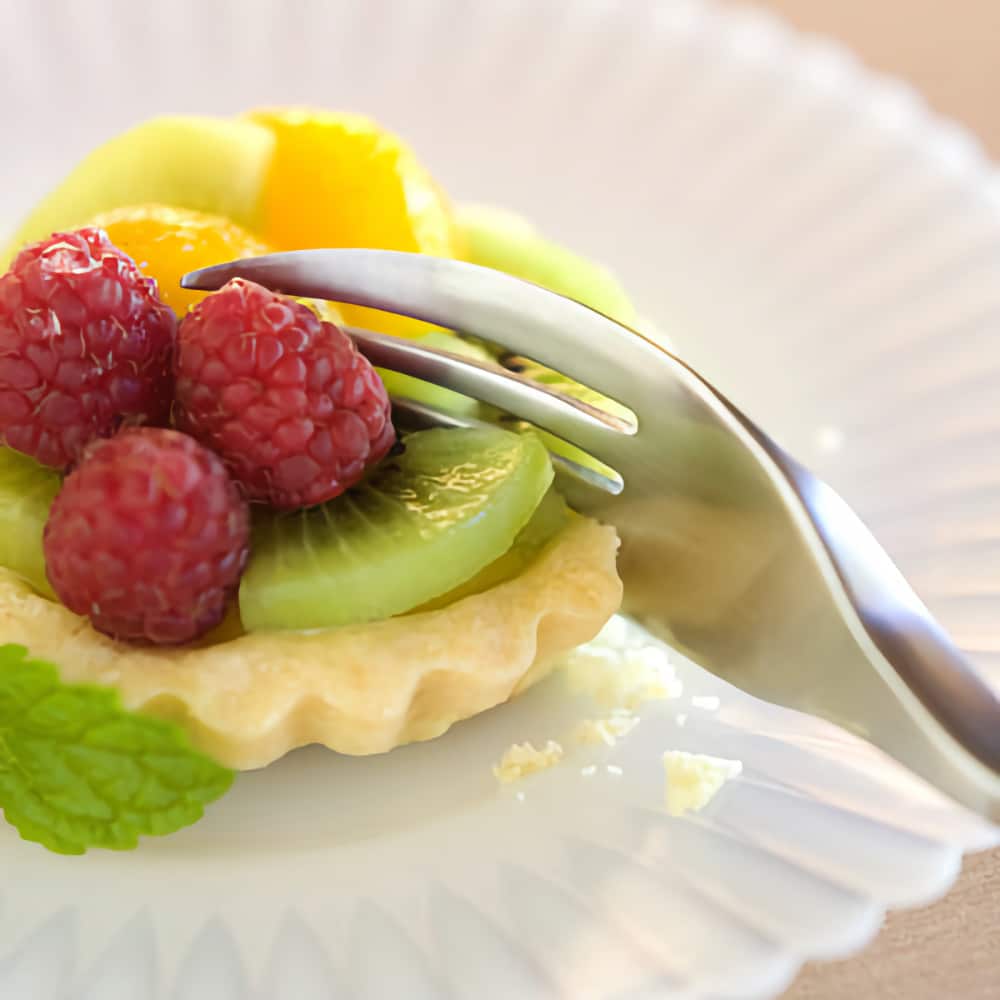 the bevelled tines on this fork can be used to cut through food like the fruit tart shown here